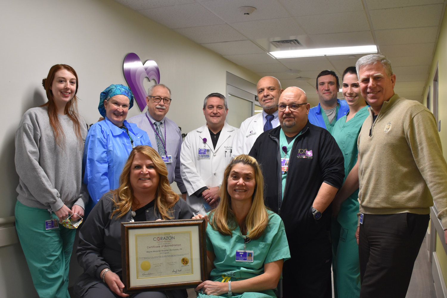 Wayne Memorial Hospital’s cardiac catheterization lab, the Heart and Vascular Center, has been re-accredited. Pictured are, standing: Cassidy Cohen, left; Colleen Shaffer; James Hockenbury; Dr. Bradley Serwer; Dr. Walid Hassan; Frank Reid; Chris Fehnel; Kristen Schmale; and Rob Brzuchalski. Seated are Sandra Skrobiszewski, left, and Holly Reddock.